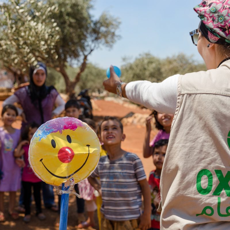 Oxfam's WASH team animates outdoor games for children in an informal Syrian refugee settlement in North Lebanon.